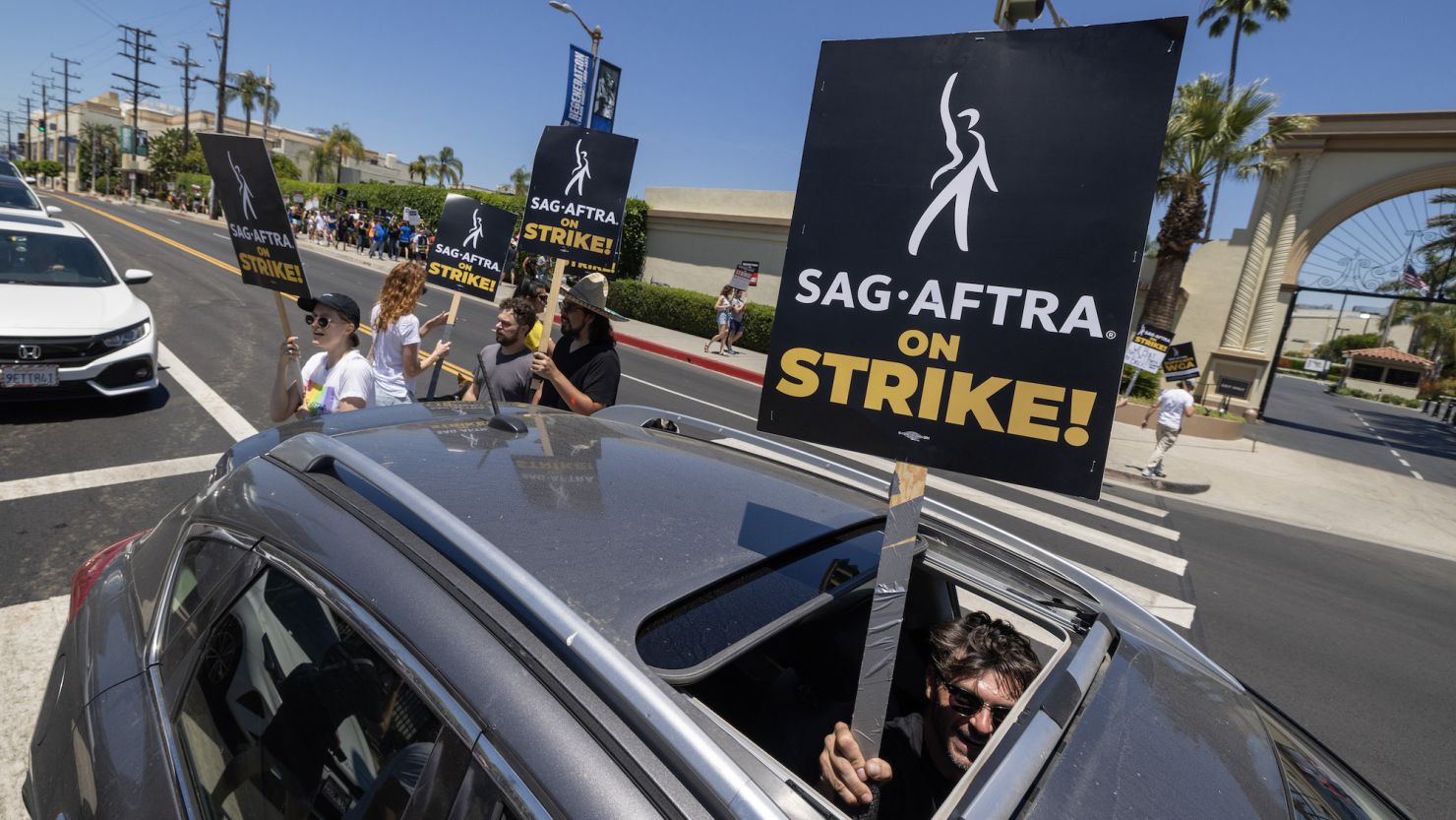 LOS ANGELES, CALIFORNIA - Members of the Hollywood actors SAG-AFTRA union walk a picket line with screen writers outside of Paramount Studios on the first day of the actors' strike which piles on top of the Hollywood writers WGA union strike. (Photo by David McNew/Getty Images)