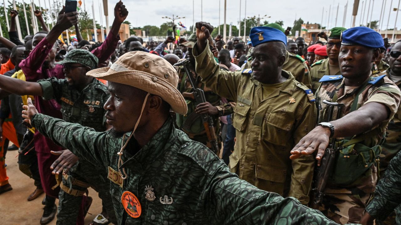 TOPSHOT - Niger's National Council for the Safeguard of the Homeland (CNSP) Colonel-Major Amadou Abdramane (2nd R) is greeted by supporters upon his arrival at the Stade General Seyni Kountche in Niamey on August 6, 2023. Thousands of supporters of the military coup in Niger gathered at a Niamey stadium Sunday, when a deadline set by the West African regional bloc ECOWAS to return the deposed President Mohamed Bazoum to power is set to expire, according to AFP journalists. A delegation of members of the ruling National Council for the Safeguard of the Homeland (CNSP) arrived at the 30,000-seat stadium to cheers from supporters, many of whom were drapped in Russian flags and portraits of CNSP leaders. (Photo by AFP) / "The erroneous mention[s] appearing in the metadata of this photo by - has been modified in AFP systems in the following manner: [Colonel-Major Amadou Abdramane] instead of [Colonel-Major Amadou Adramane]. Please immediately remove the erroneous mention[s] from all your online services and delete it (them) from your servers. If you have been authorized by AFP to distribute it (them) to third parties, please ensure that the same actions are carried out by them. Failure to promptly comply with these instructions will entail liability on your part for any continued or post notification usage. Therefore we thank you very much for all your attention and prompt action. We are sorry for the inconvenience this notification may cause and remain at your disposal for any further information you may require." (Photo by -/AFP via Getty Images)