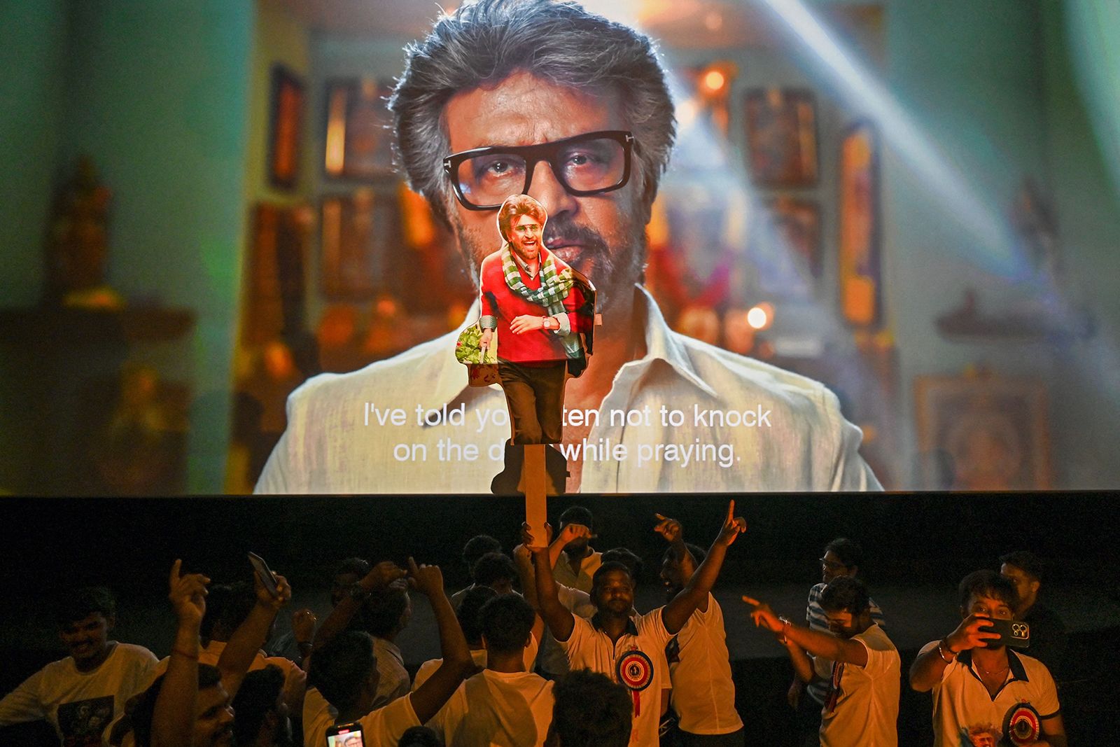 Fans dance during the screening of Indian actor Rajinikanth's new Tamil-language movie 'Jailer' on the first day of its release in Mumbai on August 10.