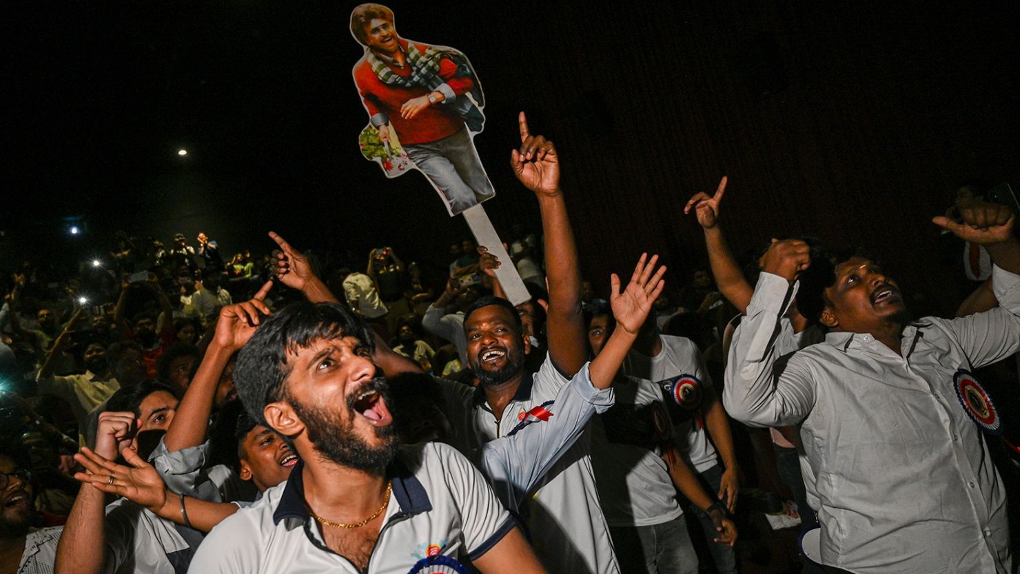Fans of Indian actor Rajinikanth dance as they celebrate the release of his latest film Jailer, during its first day-first screening, inside a cinema hall in Mumbai on August 10, 2023. 