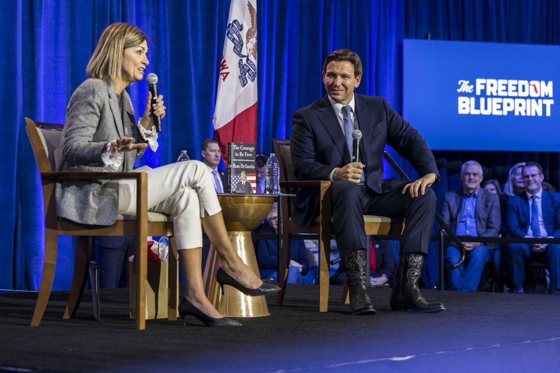 Reynolds and Florida Gov. Ron DeSantis are seen during an event in Des Moines on March 10, 2023. 