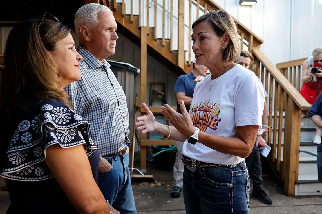 Former Vice President Mike Pence and his wife, Karen, visit with Reynolds before participating in the "fair-side chat" at the Iowa State Fair on August 11, 2023.