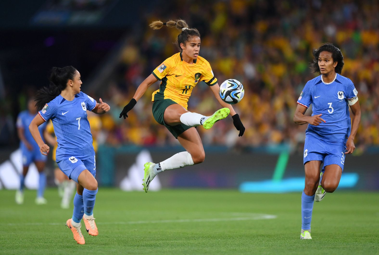 Australia's Mary Fowler controls the ball between France's Sakina Karchaoui and Wendie Renard.