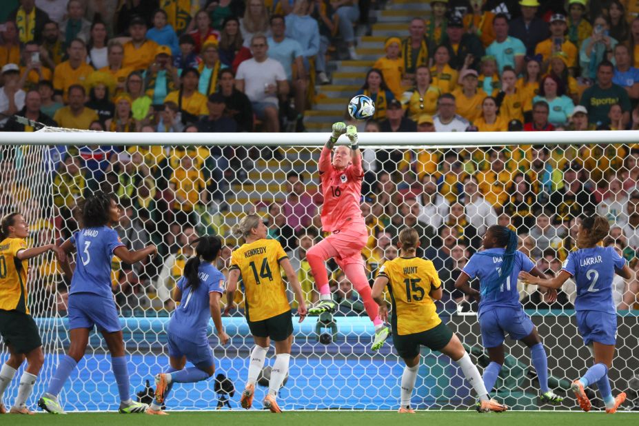 France's goalkeeper Pauline Peyraud-Magnin, centre, punches the ball away.