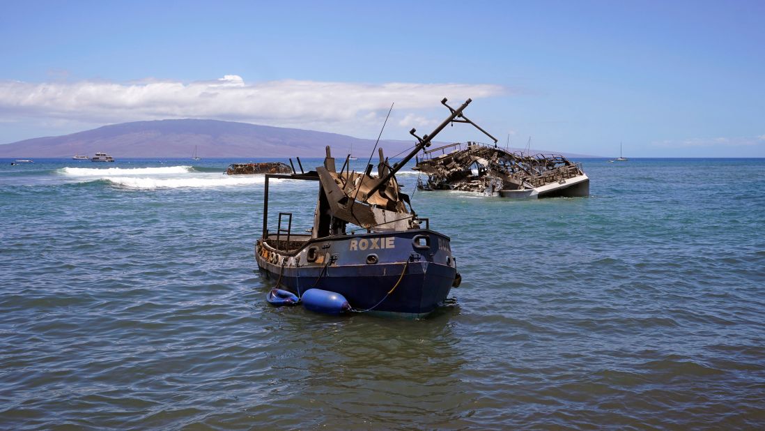 Burnt boats sit in waters off of Lahaina, Hawaii, on Friday.