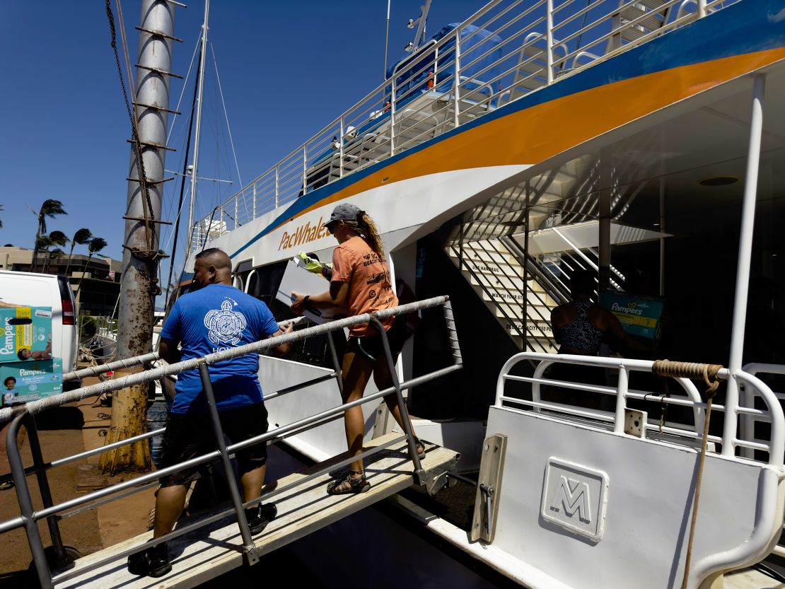 A bucket brigade supply line transporting supplies from the marina dock, through a Pacific Whale Foundation ship, onto the Ocean Spirit.