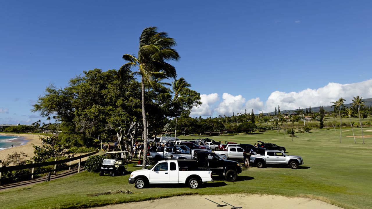 Trucks parked on the fifth hole fairway of the Royal Ka'anapali golf course, waiting to be loaded up with supplies.