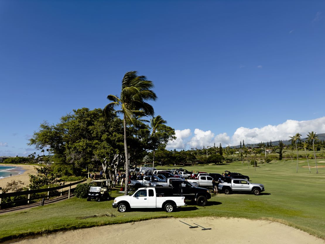 Trucks parked on the fifth hole fairway of the Royal Ka'anapali golf course, waiting to be loaded up with supplies.