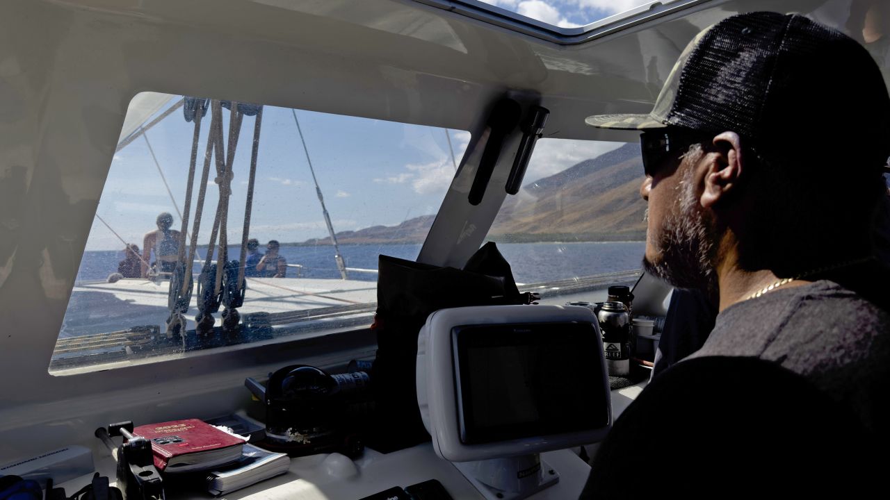 Benny Rodriguez, whose Lahaina home was destroyed in the wildfire, pilots the Ocean Spirit on the way to the supply drop location.
