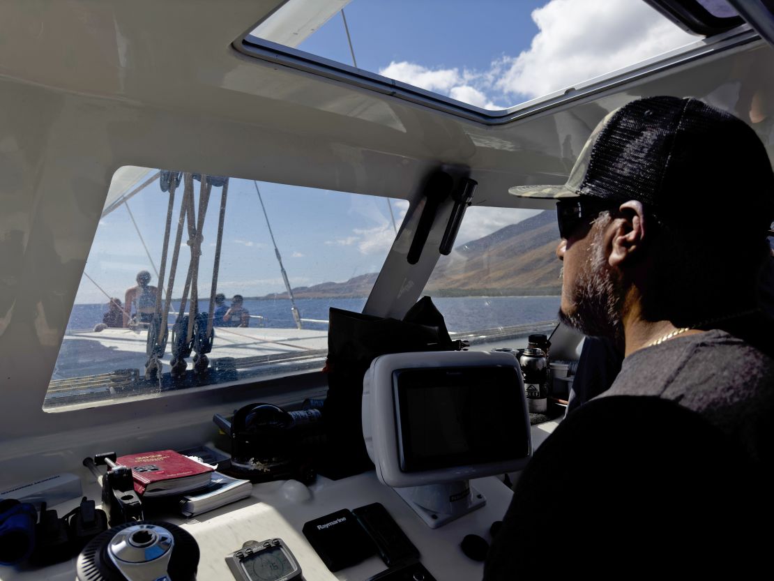 Benny Rodriguez, whose Lahaina home was destroyed in the wildfire, pilots the Ocean Spirit on the way to the supply drop location.