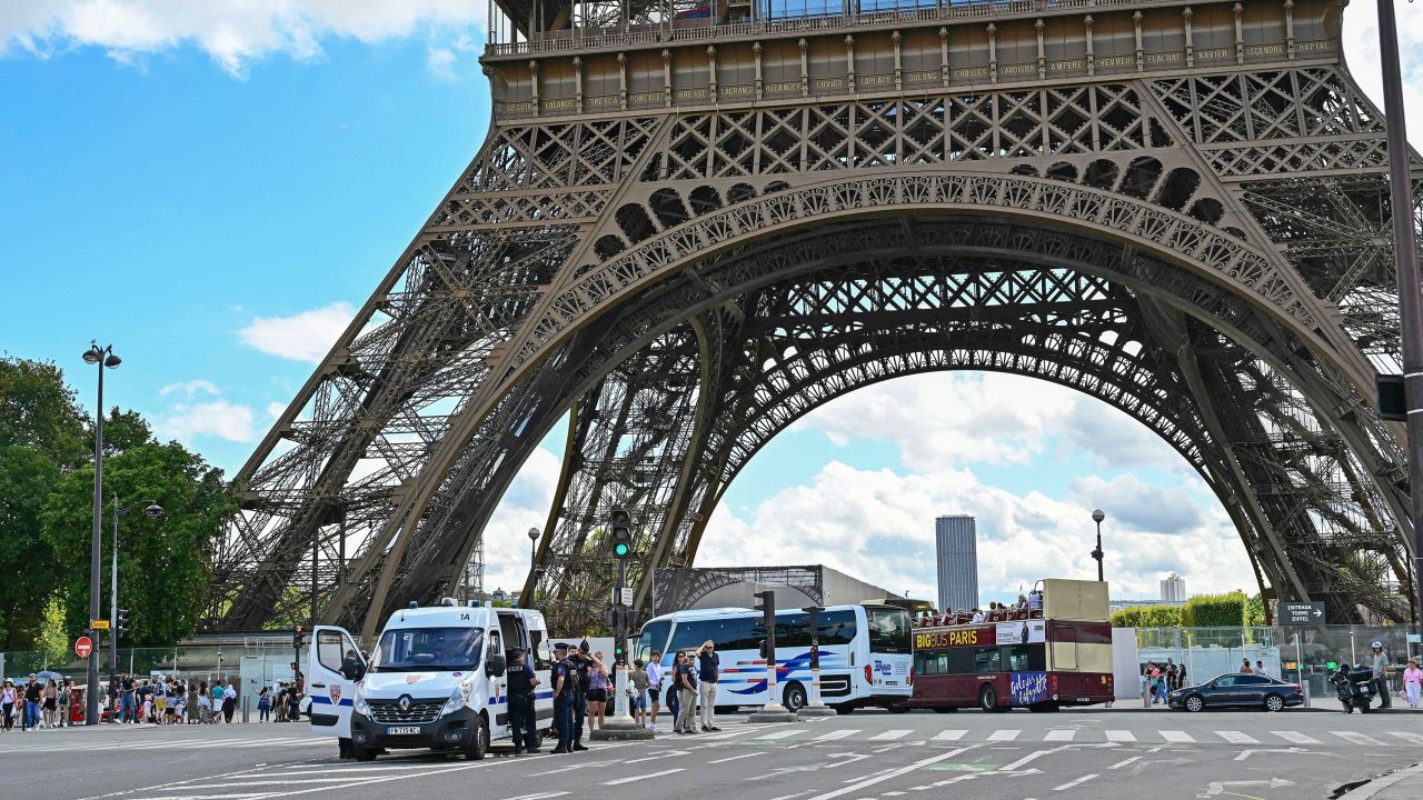 Republican Security Corps (CRS) officers secure the area in central Paris on August 12, 2023, after a security alert prompted the evacuation of three floors of the Eiffel Tower, France's most emblematic symbol which drew 6.2 million visitors last year. Police bomb disposal experts arrived on the scene following an alarm, AFP learned from the monument's operating company (Sete), confirming a report by BFMTV and visitors were evacuated from both the three floors and the square under the monument. (Photo by MIGUEL MEDINA / AFP) (Photo by MIGUEL MEDINA/AFP via Getty Images)