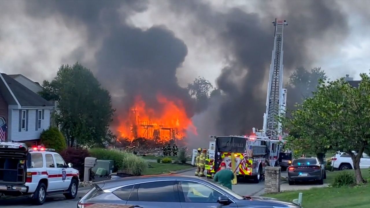 A fire is seen in Plum, Pennsylvania, after an explosion that rocked a neighborhood on Saturday.