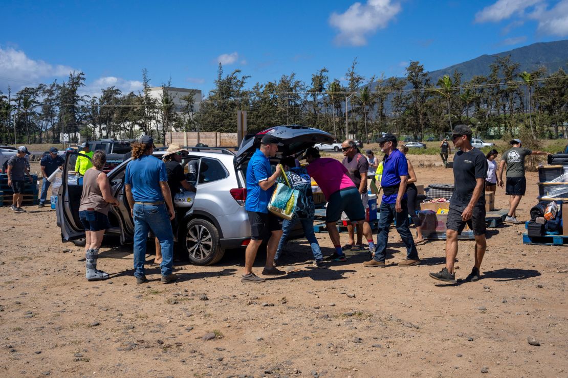 Volunteers unload supplies to be transported to people in need at Kahului Harbor in Maui, Hawaii, on Saturday.