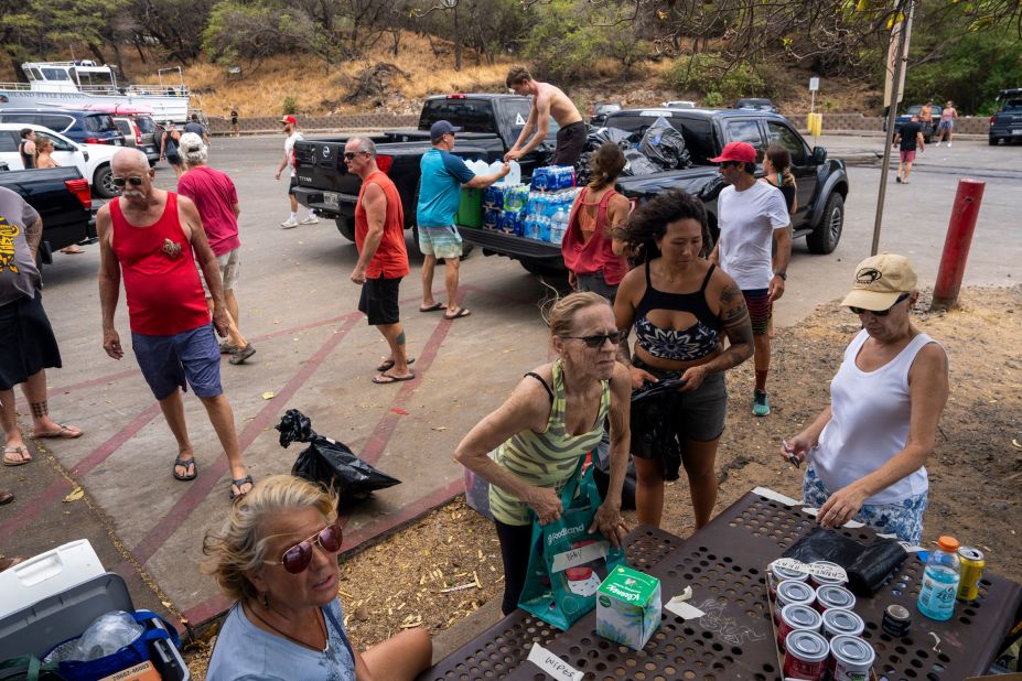 Volunteers unload supplies from trucks before loading them onto boats for people in need at Kihei Ramp in Maui, Hawaii, on Saturday, August 12.