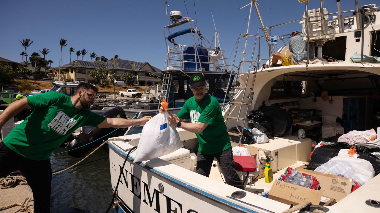 Volunteers in Maalaea, Hawaii, on August 12, 2023, load a boat with supplies to deliver to West Maui towns affected by wildfires. 