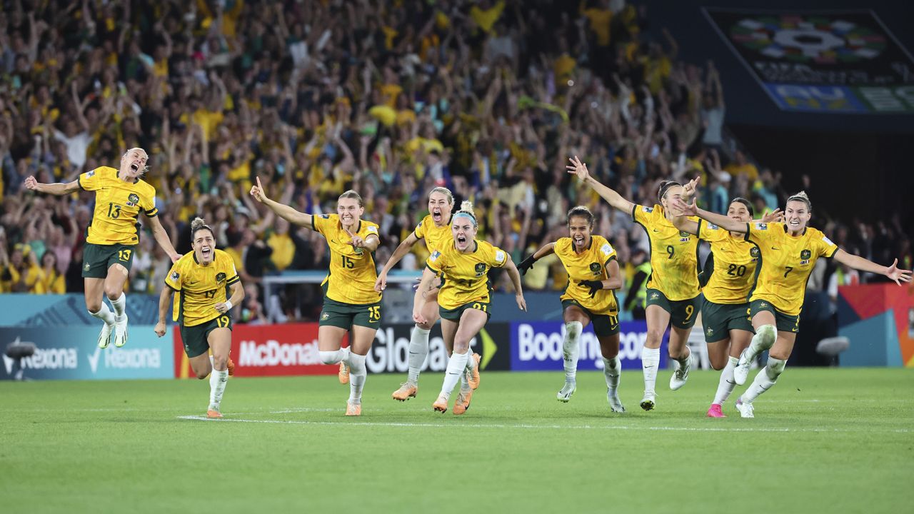 Australia players celebrate after winning their quarterfinal match against France in Brisbane, August 12.