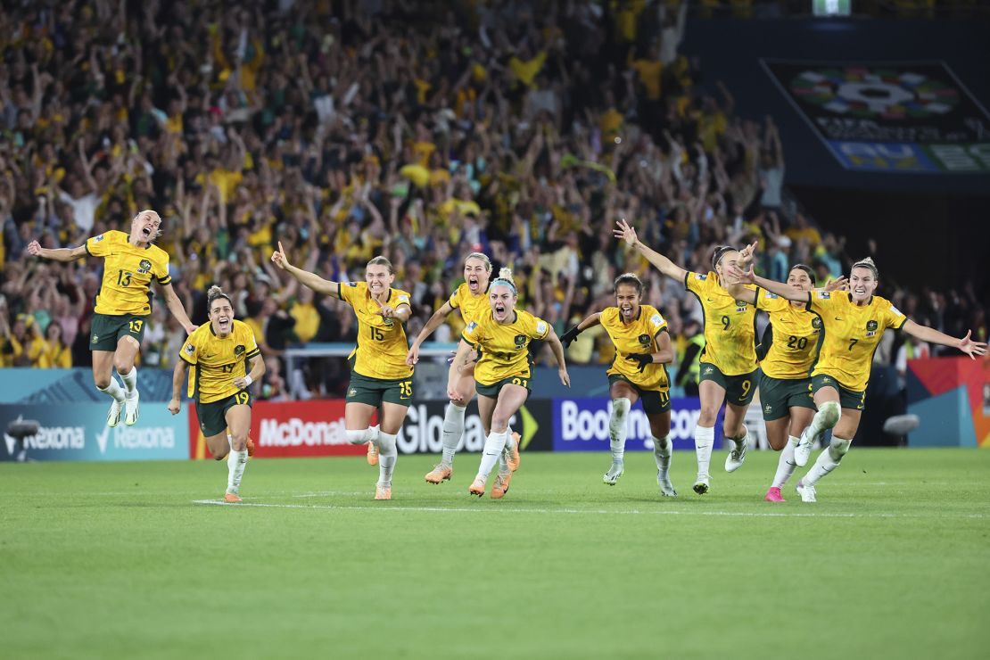 Australia players celebrate after winning their quarterfinal match against France in Brisbane, August 12.