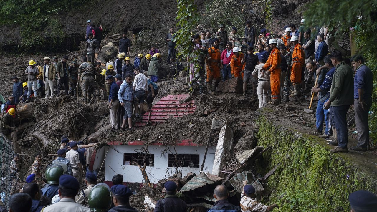 Rescuers remove mud and debris as they search for people feared trapped after a landslide near a temple on the outskirts of Shimla, Himachal Pradesh state, Monday, August 14, 2023. 