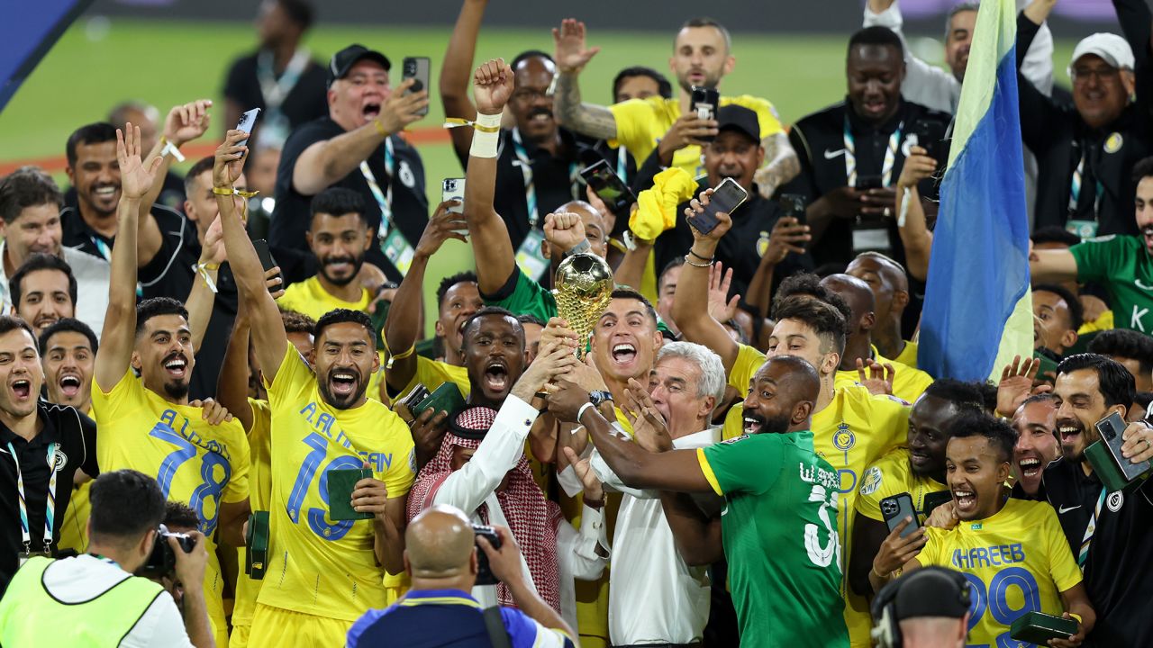 RIYADH, SAUDI ARABIA - AUGUST 12: Cristiano Ronaldo of Al Nassr lifts the Arab Club Champions Cup trophy with teammates after the team's victory in the Arab Club Champions Cup Final between Al Hilal and Al Nassr at King Fahd International Stadium on August 12, 2023 in Riyadh, Saudi Arabia. (Photo by Yasser Bakhsh/Getty Images)