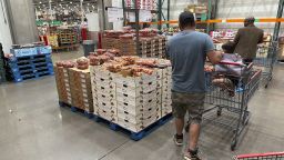 Shoppers peruse a display of Rainer cherries while pushing carts through a Costco warehouse Tuesday, July 11, 2023, in Sheridan, Colo. 