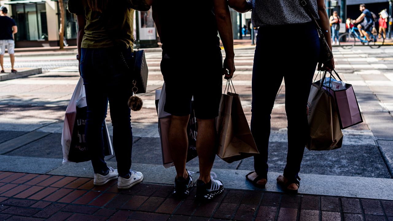 Shoppers carry bags in San Francisco, California, US, on Thursday, Sept. 29, 2022.