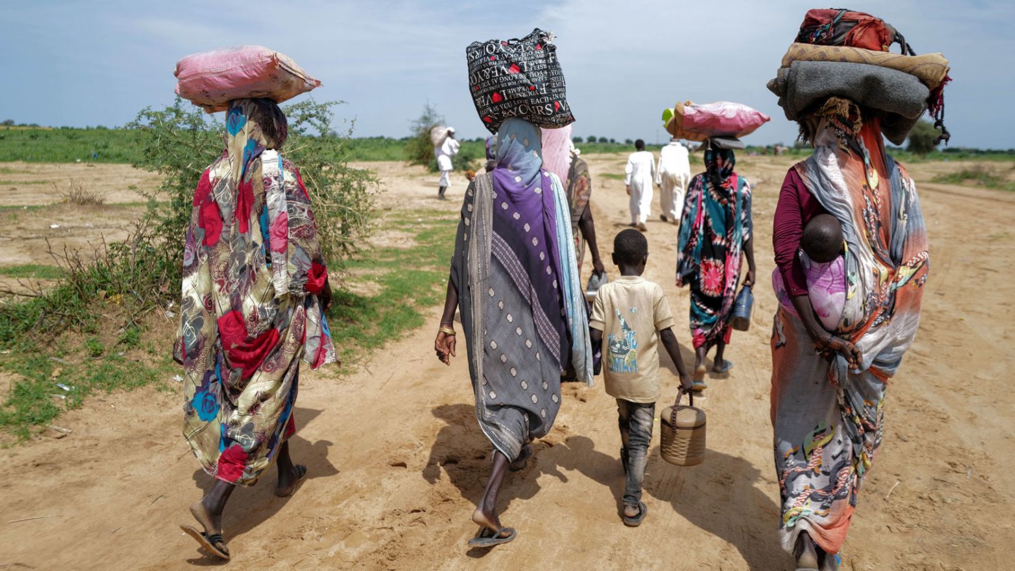 Sudanese people, who fled the conflict in Murnei in Sudan's Darfur region, walk upon crossing the border between Sudan and Chad in Adre, Chad August 2, 2023. REUTERS/Zohra Bensemra