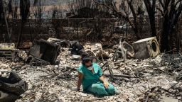 Sarah Salmonese sits where her apartment once stood in Lahaina, Maui, Hawaii, two days after it was devastated by wildfire, on Friday, Aug. 11, 2023. The death toll from the wildfires in Maui rose to 80 late Friday, and officials said the tally was expected to rise as federal help arrives to begin searches inside badly damaged structures.  (Go Nakamura/The New York Times)