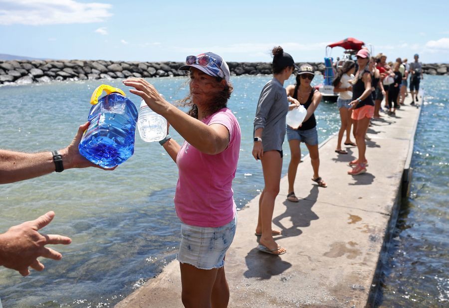Volunteers in Kihei, Hawaii, load water onto a boat to be transported to West Maui on August 13.