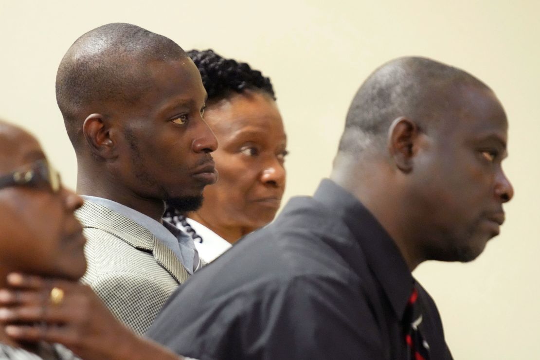 Michael Corey Jenkins, center, and Eddie Terrell Parker, right, listen as one of six former Mississippi law officers pleads guilty to state charges at the Rankin County Circuit Court in Brandon, Mississippi.