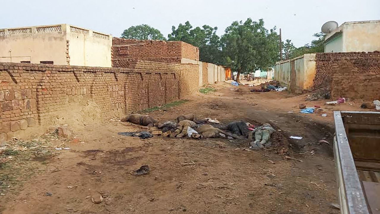 A picture taken on June 16, 2023, shows bodies strewn outdoors near houses in the West Darfur capital El Geneina. 