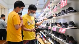 People select shoes in a shopping mall in Beijing on June 15, 2023. (Photo by WANG Zhao / AFP) (Photo by WANG ZHAO/AFP via Getty Images)