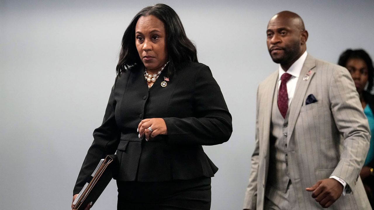 Fulton County District Attorney Fani Willis enteres a room in the Fulton County Government Center ahead of a news conference, Monday, Aug. 14, 2023, in Atlanta. 
