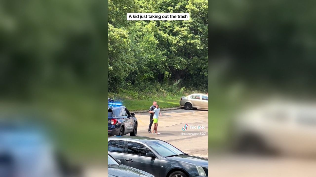 Tashawn Bernard is handcuffed by police while taking out the trash.
