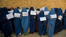 Afghan women wearing a burqa hold placards as they protest for their right to education, in Mazar-i-Sharif on August 12, 2023. 