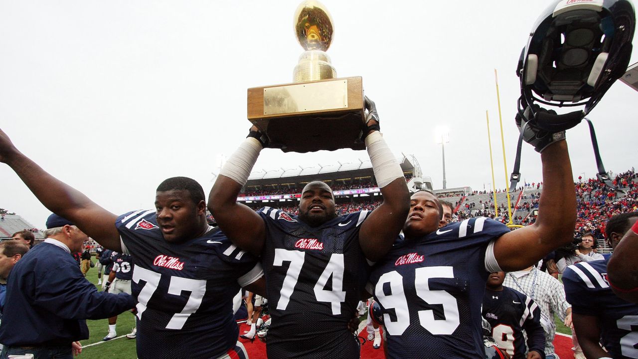 Michael Oher hoists the Golden Egg trophy with teammates after Ole Miss beat Mississippi State on November 28, 2008, in Oxford, Mississippi.