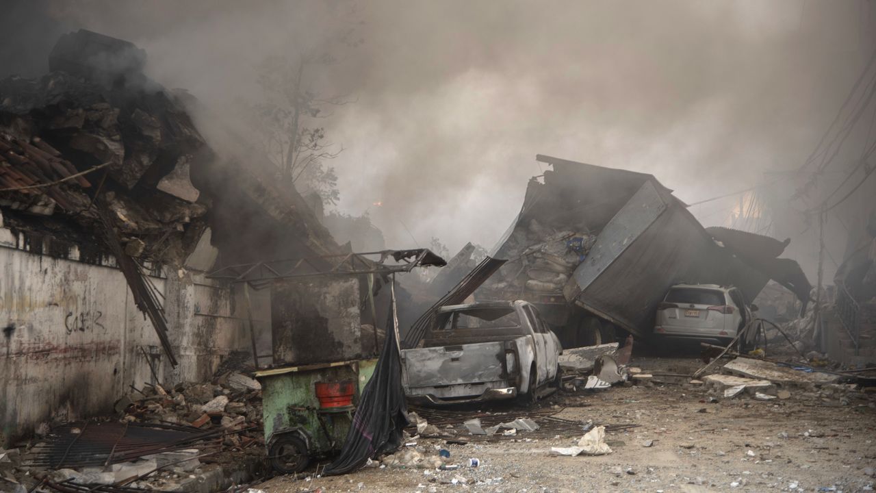 Destroyed vehicles and debris are scattered on the ground after the incident in San Cristobal.