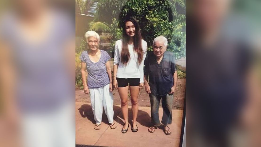 CNN Business Writer Catherine Thorbecke (center) with her late grandparents in Lahaina, Hawaii, circa 2013. Her grandparents passed away before the 2023 fires, but the home they lived in and gardens they planted are destroyed.