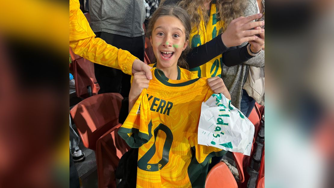 Zara Borcak beams as she holds the jersey Sam Kerr gave her after Saturday's match against France, August 12, 2023.