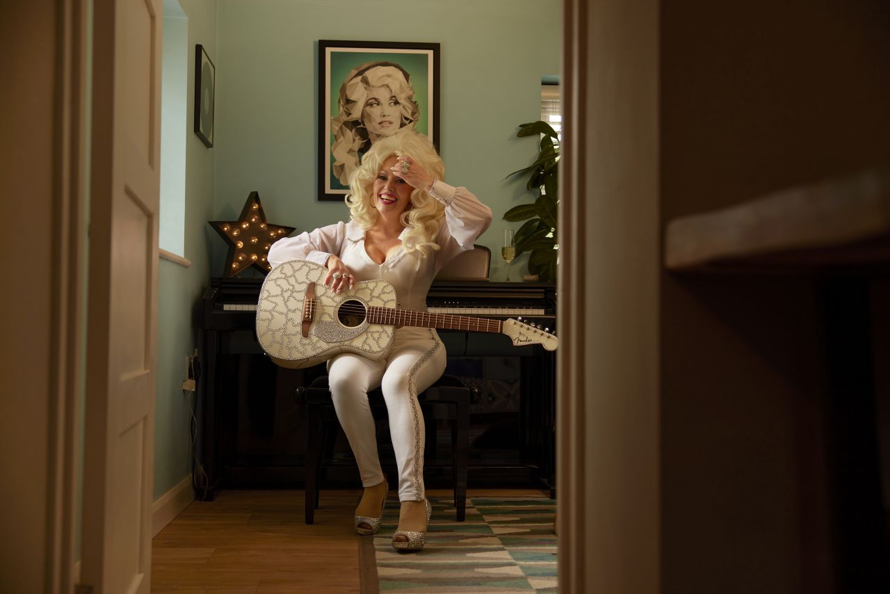 In “Dear Dolly,” the touchstones of Parton’s style and career, from her guitar to her signature hair, form a visual lexicon.