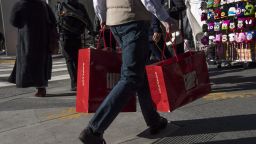 A shopper carries Gump's Corp. shopping bags in San Francisco, California, U.S., on Monday, Dec. 26, 2016. 