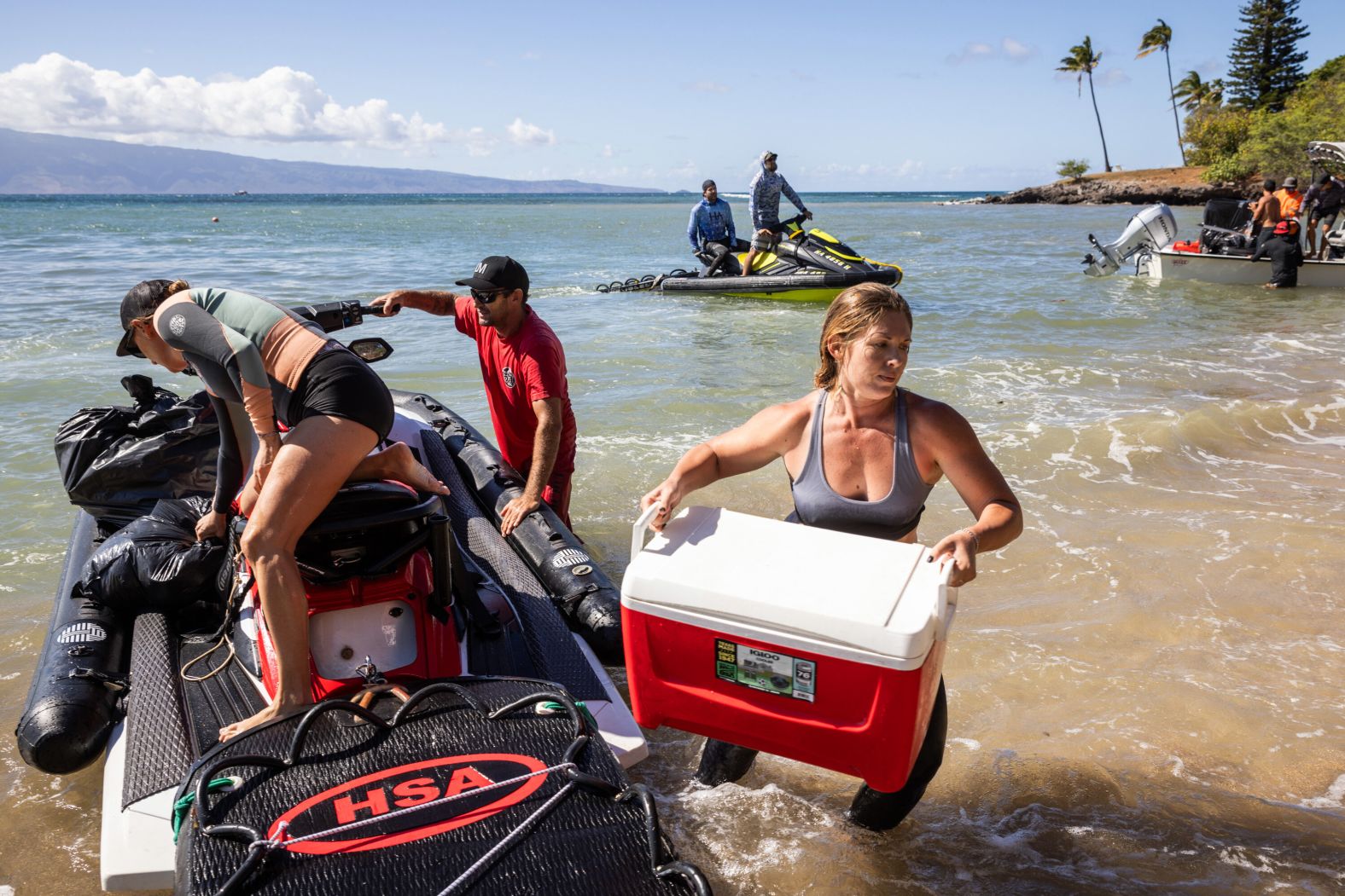 Volunteers offload supplies that would be delivered to a distribution center for evacuees in Napili-Honokowai, Hawaii, on August 12.