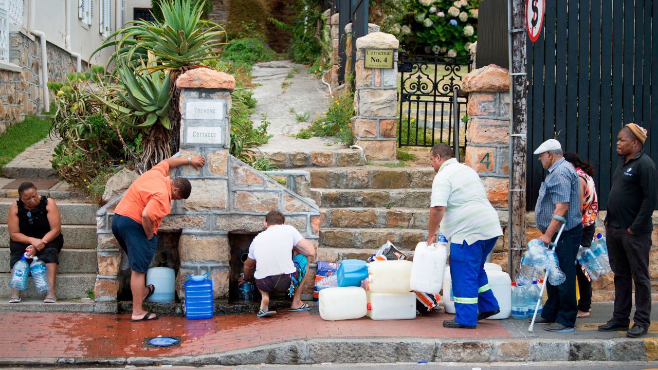 People collect drinking water from in Cape Town on January 19, 2018, during a water crisis which saw the city nearly run dry. 