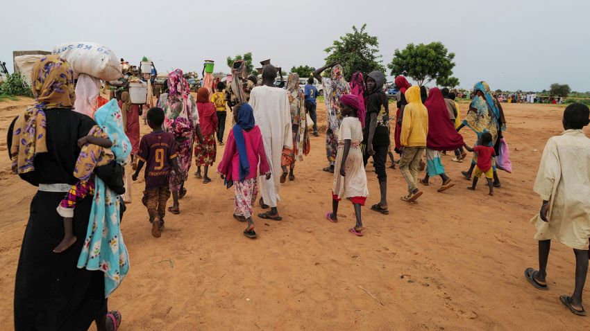 Sudanese people, who fled the conflict in Murnei in Sudan's Darfur region, walk while crossing the border between Sudan and Chad in Adre, Chad August 4, 2023. REUTERS/Zohra Bensemra