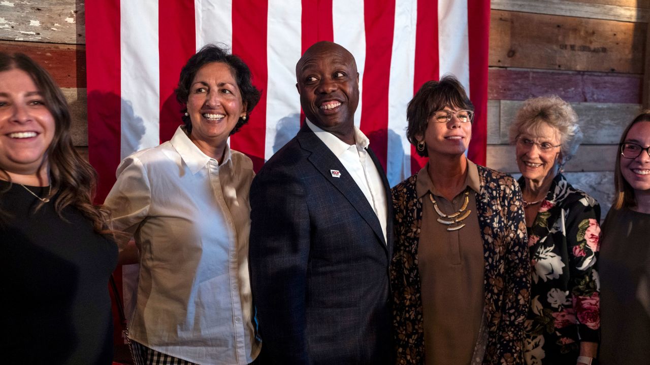 Sen. Tim Scott, a candidate for the Republican presidential nomination, poses for a photo with attendees while campaigning at the Story County Lincoln Dinner in Cambridge, Iowa, on Tuesday night, Aug. 15, 2023. 
