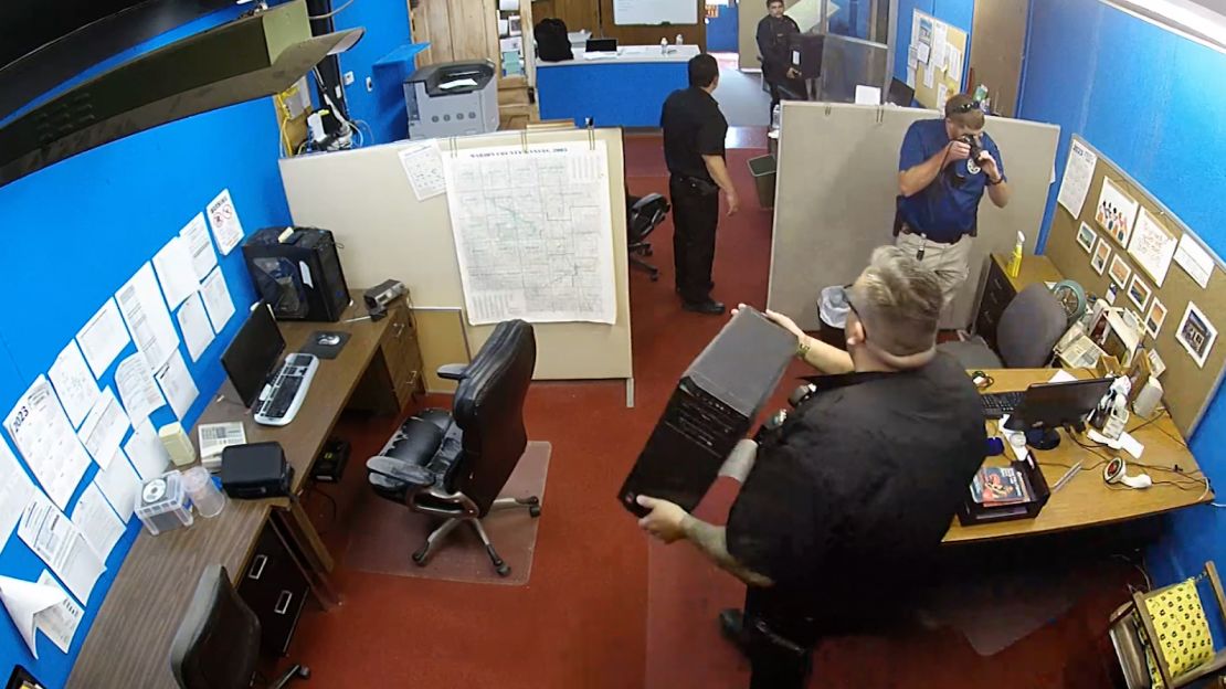 Surveillance video shows police raiding the Marion County Record's office in Kansas on Friday.