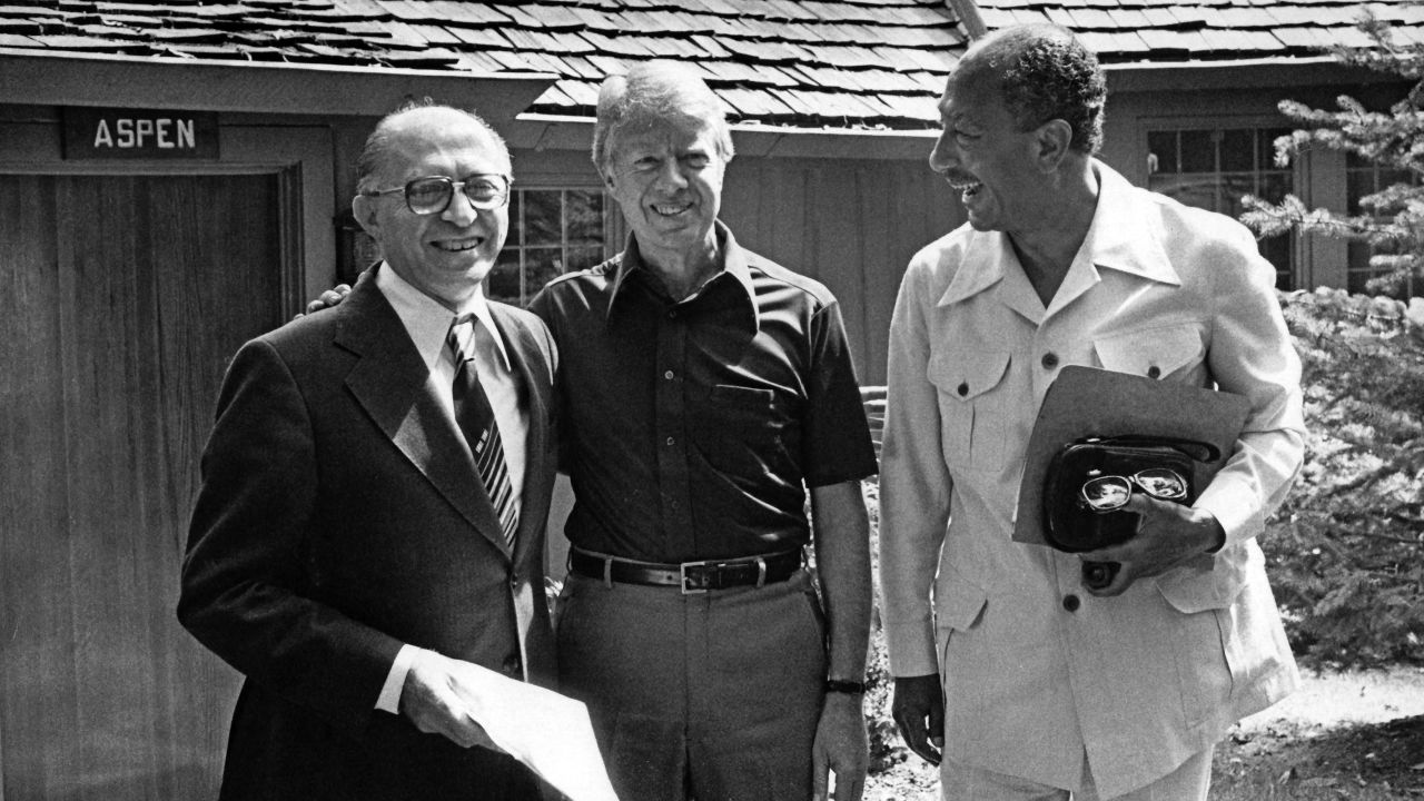 Portrait of from left, Israeli Prime Minister Menachem Begin (1913 - 1992), US President Jimmy Carter, and Egyptian President Anwar Al Sadat (1918 - 1981) as they pose together during the Egyptian-Israeli peace negotiations, in front of Aspen Lodge at Camp David, near Thurmont, Maryland, September 12, 1978. The negotiations resulted in the 'Camp David Accords' which were formalized as the 'Egypt--Israel Peace Treaty' the following year, in Washington DC on March 26, 1979. (Photo by White House via CNP/Getty Images)