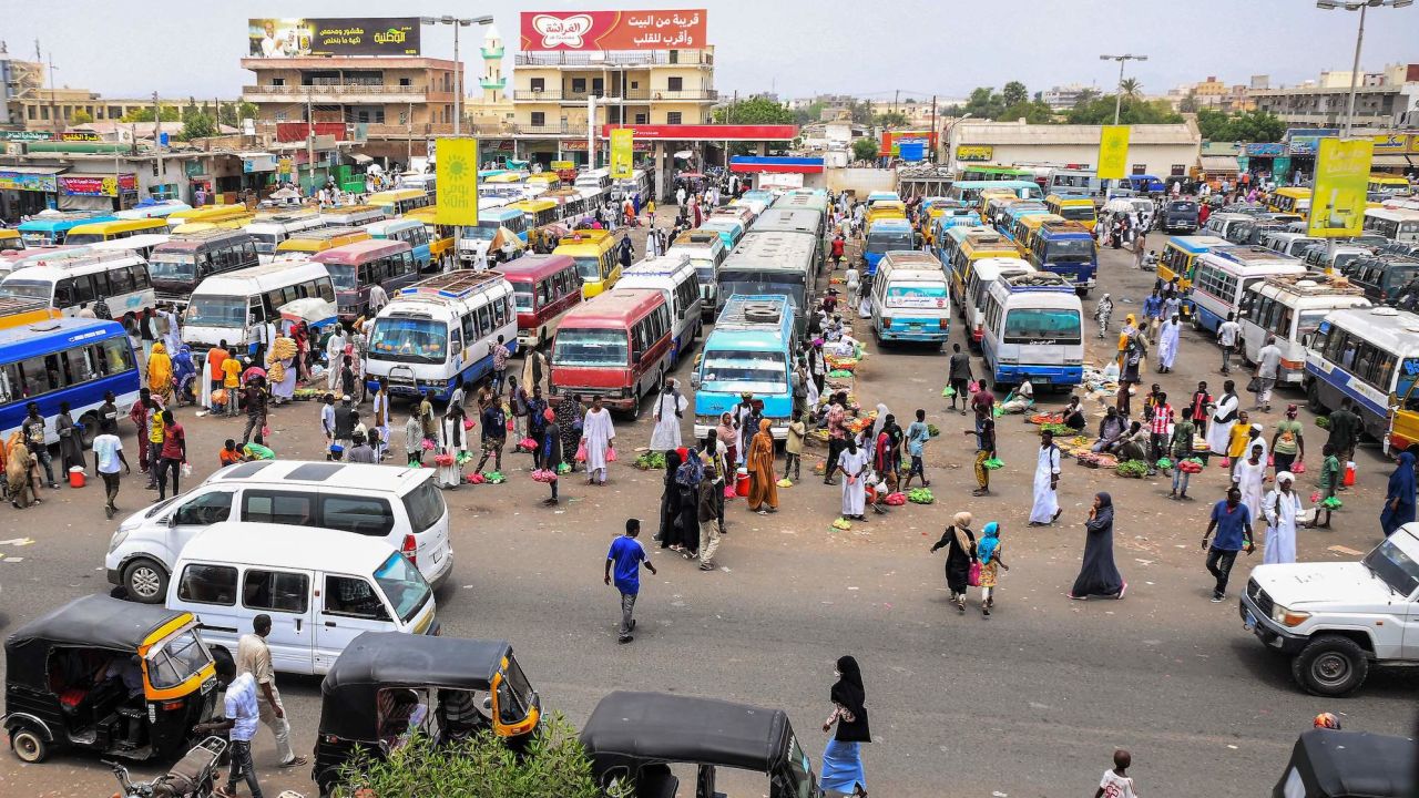 Vendors wait by minibuses and tuk-tuks for customers and passengers at a bus station in Port Sudan on May 23, 2023. The coastal city has become a hub for refugees trying to flee Sudan.