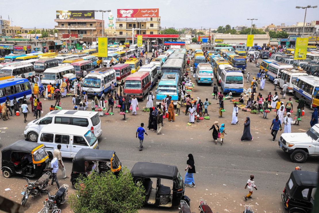 Vendors wait by minibuses and tuk-tuks for customers and passengers at a bus station in Port Sudan on May 23, 2023. The coastal city has become a hub for refugees trying to flee Sudan.