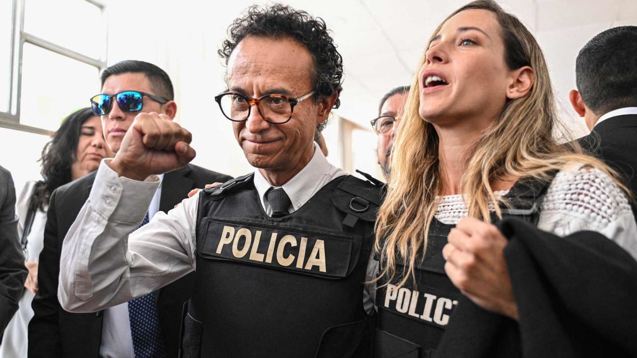 Journalist and presidential candidate Christian Zurita gestures next to his running mate, vice presidential candidate Andrea Gonzalez (R), in Quito on August 13, 2023.