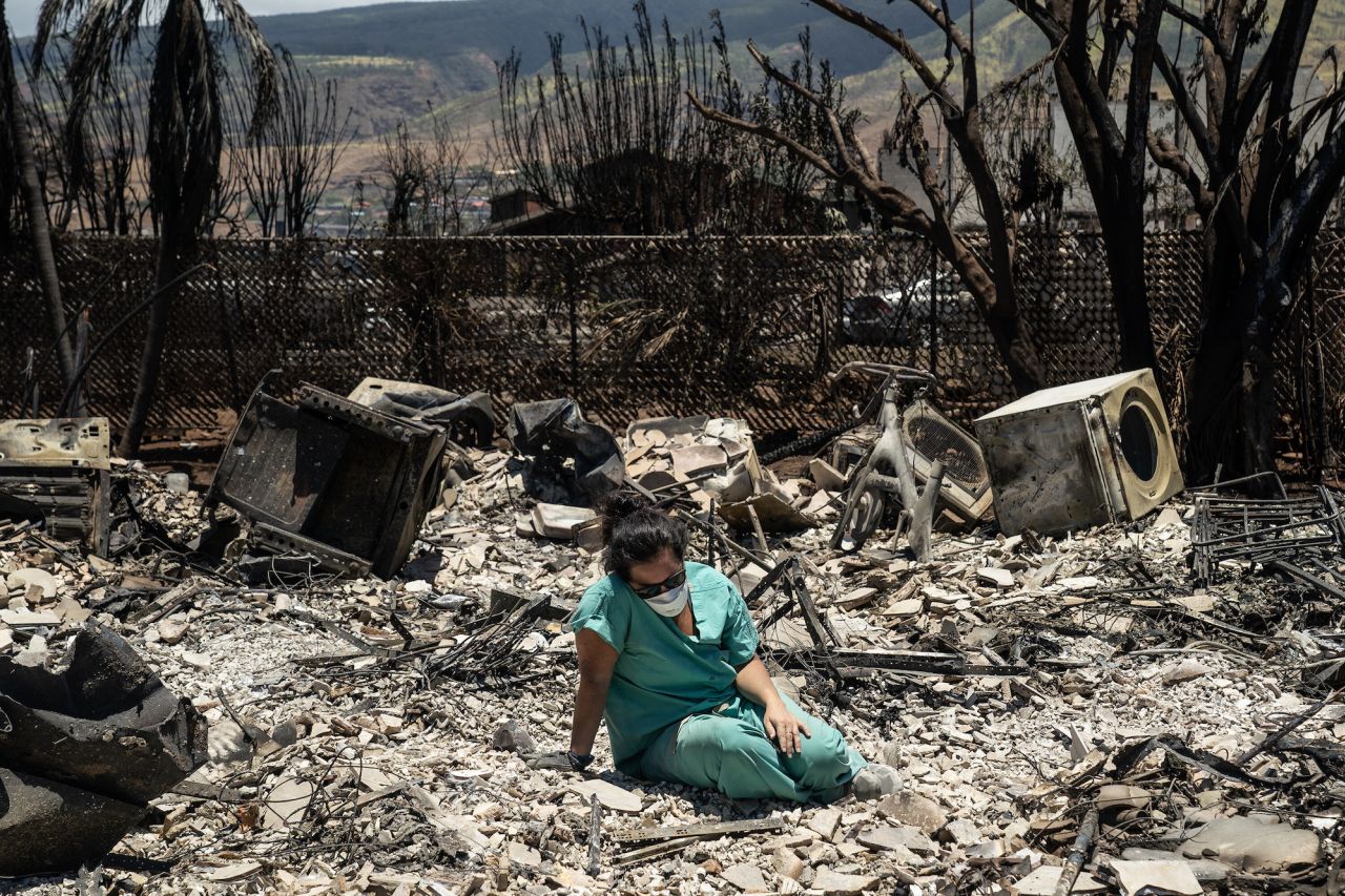 Sarah Salmonese sits where her apartment once stood in Lahaina, Hawaii, on Friday, August 11. <a href="https://www.cnn.com/2023/08/10/weather/gallery/maui-fire-gallery/index.html" target="_blank">Catastrophic wildfires</a> have killed dozens of people on the Hawaiian island of Maui, and the blaze that devastated the historic town of Lahaina is now the deadliest US wildfire in over 100 years, officials said.